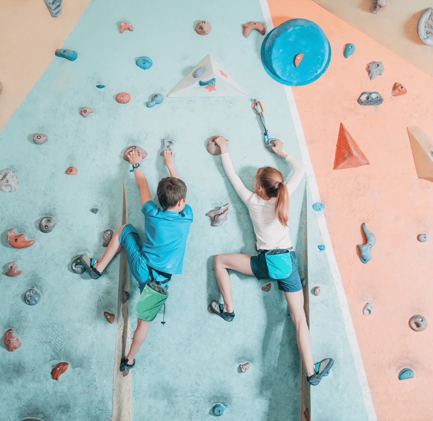 Kids climbing an indoor rock wall during adventure activities at camp
